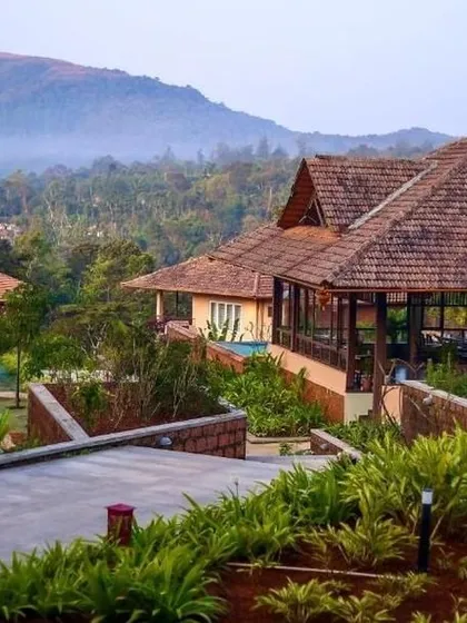 The beautiful architecture of this resort in Sakleshpur, with its tiled roofs and landscaped gardens, offers a luxurious escape with stunning mountain views.