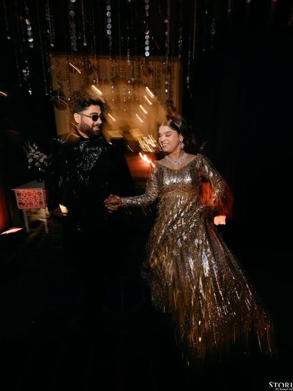 A creative motion-blur shot of the couple dancing, conveying the energy and excitement of their celebration.