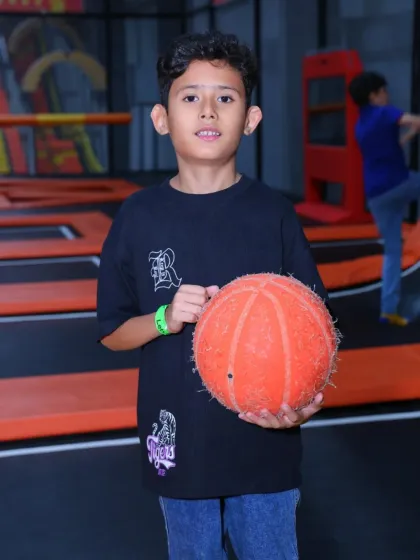 Ready to play some trampoline basketball. This young guest is all set to test his aim while bouncing high in the air.