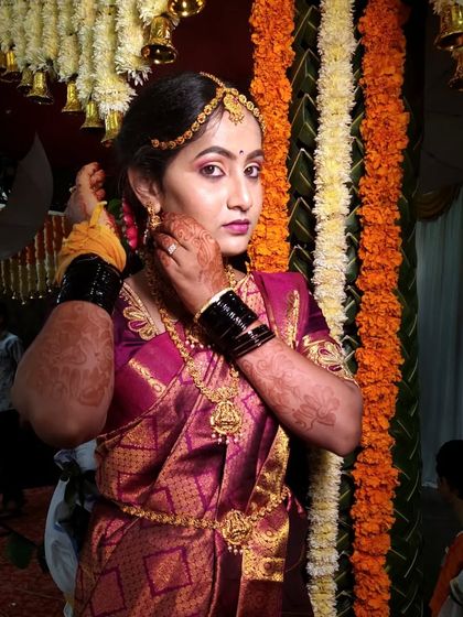 A candid moment from the ceremony. The makeup is designed to look stunning from every angle, even in the middle of the wedding rituals.