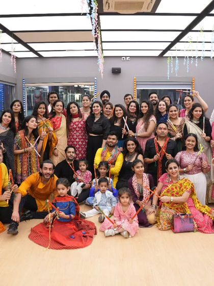 A memorable group photo from a packed Dandiya session at 21 Fitness, Vasant Kunj. It's amazing to see so many people, including children, come together to celebrate and dance.