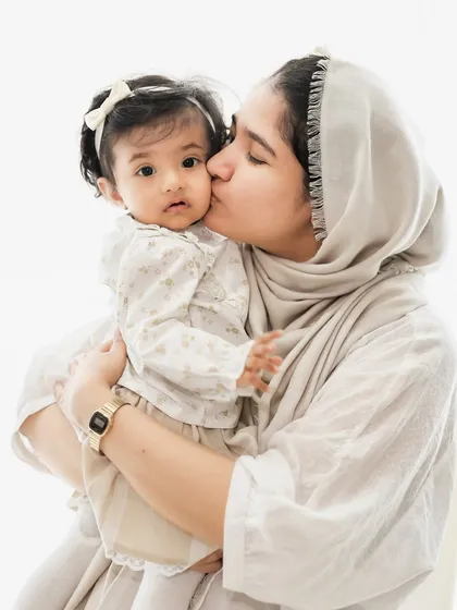 A mother's gentle kiss. We aim to capture these simple, tender interactions that show the deep bond between a parent and child, creating memories you will cherish forever.