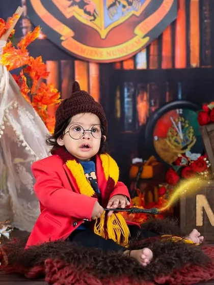 Wingardium Leviosa. A magical Harry Potter themed shoot for a little wizard turning one, complete with a wand, glasses, and a Gryffindor scarf.