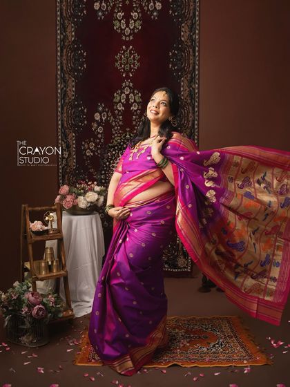 The flowing fabric of her traditional saree adds a dynamic and celebratory feel to this portrait. It’s a beautiful way to capture the energy and excitement of this special time.