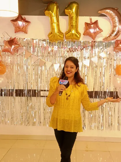 Ready to host an 11th birthday party, and my outfit coincidentally matched the decor. I always bring my professional microphone and a plan to keep energetic kids entertained.