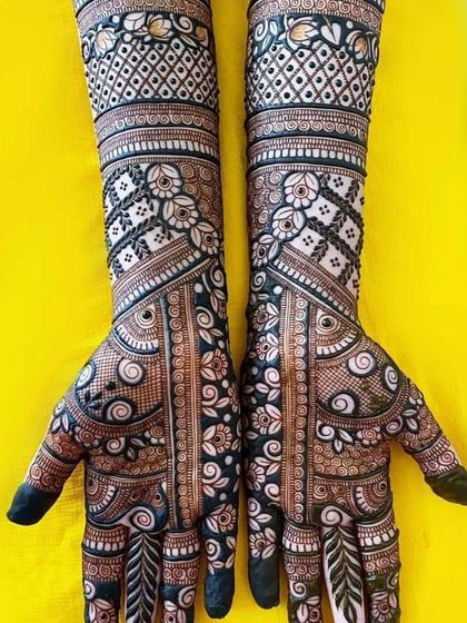 A stunning example of full-coverage bridal mehndi, with vertical panels of floral and geometric patterns creating a unique and elongated look.