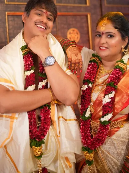 Gayathri and her groom during the wedding ceremony. Her traditional white and red saree look is timeless.