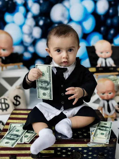 Showing off the cash! This is a classic "Boss Baby" pose that always gets a laugh.