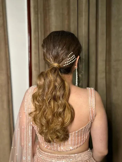 Another angle of the textured ponytail, showing the placement of the pearl accessory.