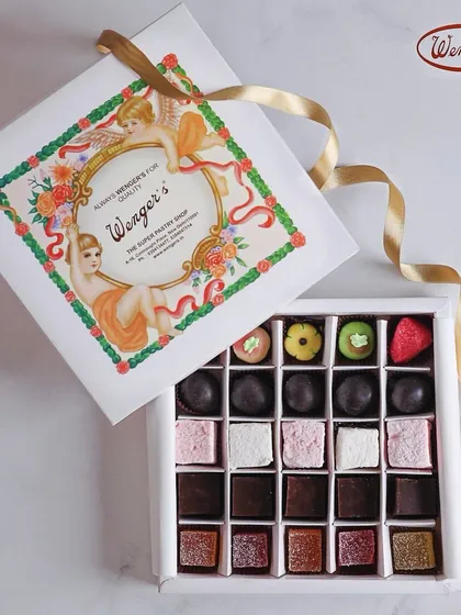 Our iconic white box is a little box of happiness. Here it is, filled with an assortment of our handmade confections, including colourful marzipan fruits, soft marshmallows, rich fudge, and classic chocolate truffles.