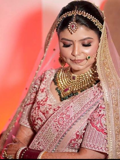 A serene shot of the bride, looking down with a gentle smile.