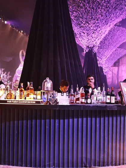 A sleek, modern bar setup, fully stocked and manned by our professional bartenders, ready to craft exquisite cocktails for your guests.