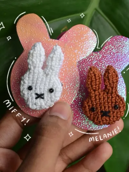 My Miffy and Melanie matching pins displayed on a sparkly, custom-cut backing card. I love making the presentation as cute as the product.
