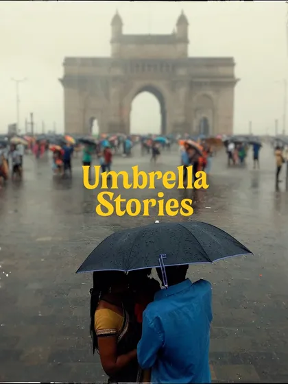 Titled "Umbrella Stories," this image shows a couple under an umbrella in front of the Gateway of India. The soft focus and vintage feel give it a timeless, storybook quality.