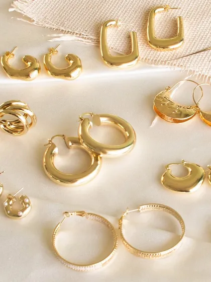 A flat lay of our go-to hoops for any occasion. This image showcases the variety in our collection, from classic round hoops to modern rectangular designs.