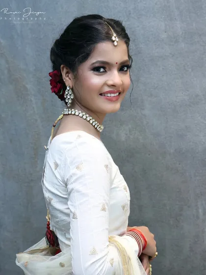 A final portrait showing her looking over her shoulder, giving a great view of the hairstyle and makeup.