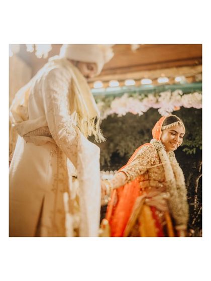 A low-angle shot of the couple during their ceremony, capturing a sweet, candid interaction.