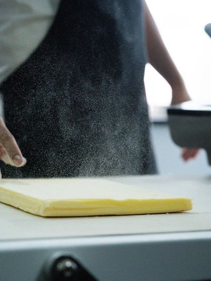 The art of lamination begins with a perfectly prepared butter block, a core focus in our Viennoiserie training.