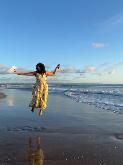 Jumping for joy on a beach in Bali. This lemon-print maxi dress is fun, vibrant, and perfect for a tropical getaway.
