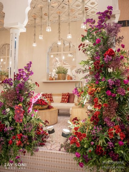 Another perspective of the lounge, framed by towering floral pillars that guide the eye towards the comfortable seating areas in the background.