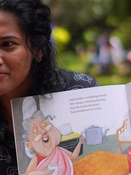 A close-up of me reading, showing the colorful illustrations to the children. Visuals are a key part of storytelling for this age group, and I make sure everyone gets a good look.