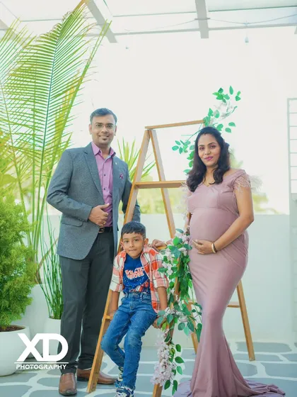 A beautiful family portrait with their son, captured in a bright and airy indoor studio setting.