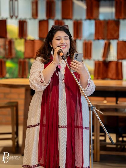 A performer beams with joy as she shares her poem. The positive feedback and warm reception from the audience make performing a rewarding experience.