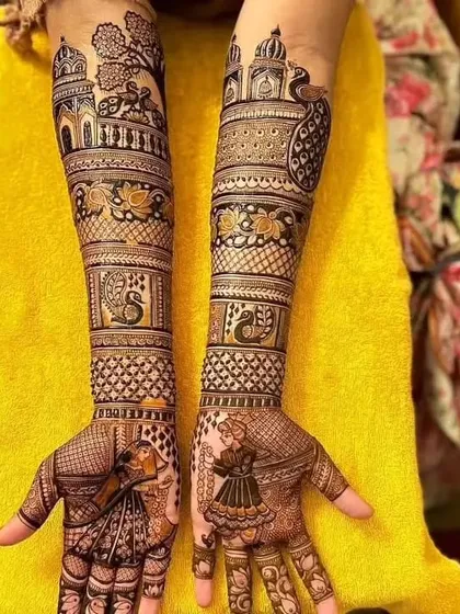 A beautiful portrait design telling a story. The palms show the couple in a dance pose, while the arms are decorated with peacocks, lotuses, and palace scenery.