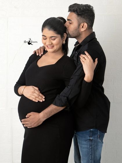 A sweet kiss on the head while he cradles her and the baby bump. This is a classic pose that beautifully expresses love and protection.