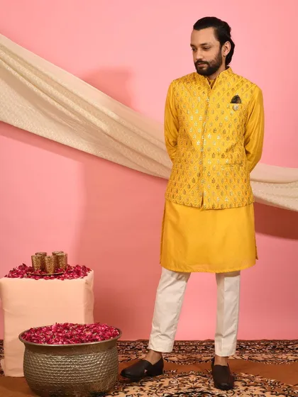 A complete look featuring the bright yellow Nehru jacket, paired with a matching kurta and contrasting white trousers. This outfit is a great example of how to wear bold color with confidence and style.