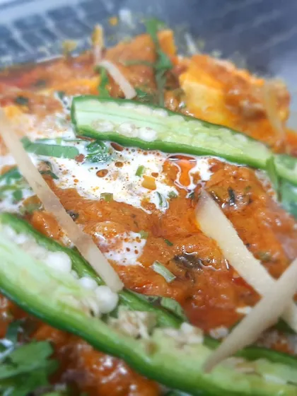 A detailed shot of our Paneer Lababdar, highlighting the creamy gravy and the fresh green chilli and ginger garnish.