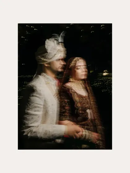 An artistic, motion-blur portrait of the couple at night. This creative shot captures a fleeting, dreamlike moment of their wedding day.