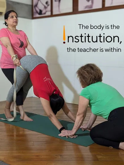 "The body is the institution, the teacher is within." This quote captures the essence of our practice. Here, my team and I are guiding a student in Adho Mukha Svanasana (Downward Facing Dog) using a belt to teach the correct action of the hips and spine.