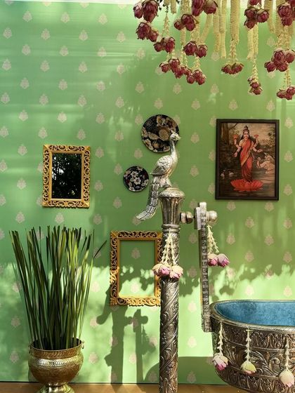 A detail shot of the silver cradle post, adorned with a silver peacock and floral tassels.