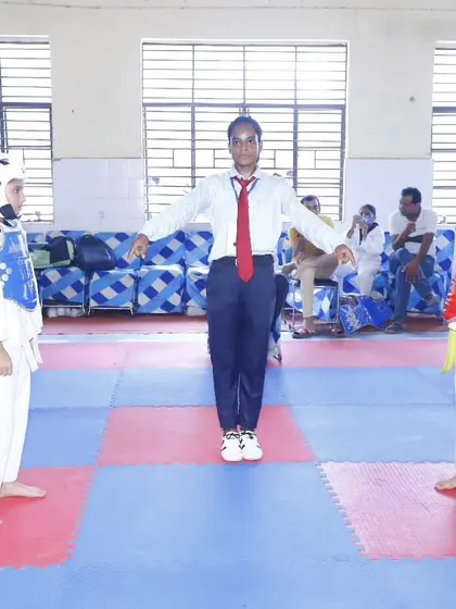 A referee officiates a match between two young girls. We encourage sportsmanship and fair play in all sparring sessions.