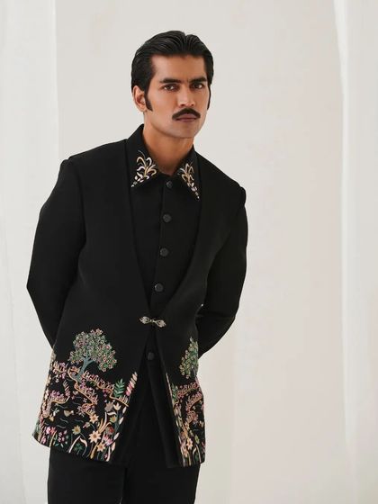 A full-length view of the black bandhgala with floral embroidery. The unique cut and detailed craftsmanship make it a standout piece for any formal occasion.