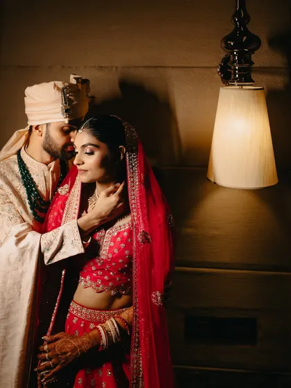 An intimate moment between the bride and groom after the ceremony. The soft lighting and gentle embrace create a timeless portrait, a quiet pause amidst the day's celebrations.