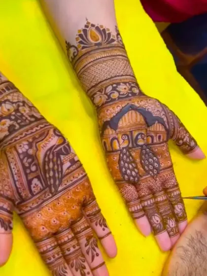 A work-in-progress shot showing the application of a peacock design on the palm.