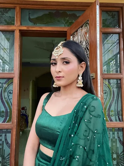 A simple yet elegant look. The focus is on the statement maang tikka and the clean, fresh makeup.