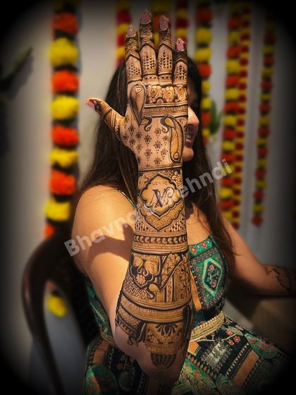 A beautiful back hand design featuring elephants and personalized initials. The intricate patterns and clean lines make this a timeless choice for any bride.