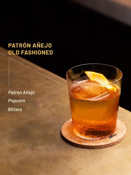 A creative twist on a classic, the Patrón Añejo Old Fashioned. We infuse the tequila with popcorn flavour and add bitters for a smooth, slightly sweet, and savoury cocktail.