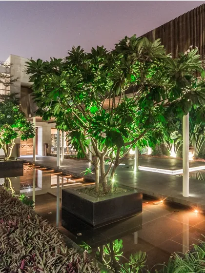 The central courtyard, with its water body and strategically lit trees, becomes a magical space at night. It acts as the home's natural heart, a place for quiet reflection and connection with the elements.