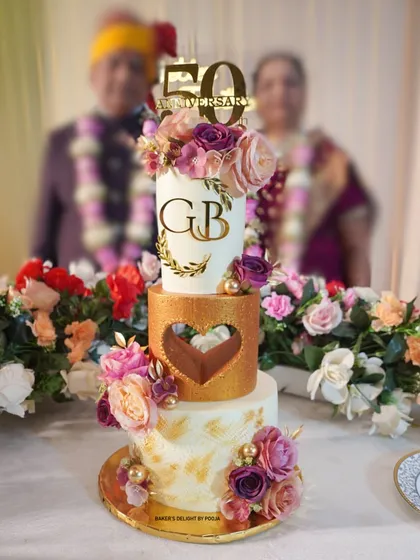 A 50th anniversary is a golden milestone that deserves a truly grand celebration. I designed this elegant, three-tier eggless cake for my own parents' special day, combining classic white and gold with beautiful floral arrangements to create a timeless centerpiece.