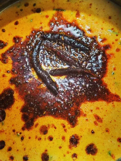 The final touch for my Punjabi Kadhi Pakora is the tadka. A sizzling tempering of spices and dried red chilies in hot oil is poured over the top to add a burst of flavour.