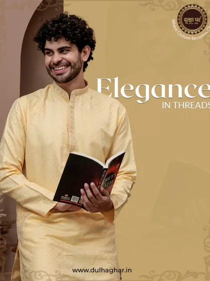 Elegance in threads. A model in a yellow kurta, holding a book, showcases a look that is both intellectual and stylish.