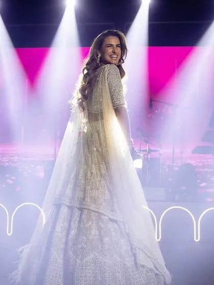 A beautiful shot of the bride, glowing under the spotlights. Her smile says everything about the joy and magic of her sangeet night.