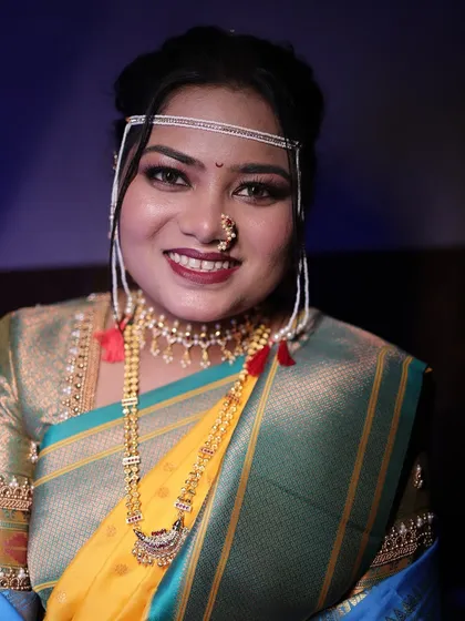 A close-up portrait of the bride, her smile radiating pure joy. The makeup is fresh and vibrant.