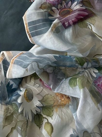 A detailed shot of the hand-painted silk chanderi dupatta, showcasing its soft floral pattern and luxurious texture.