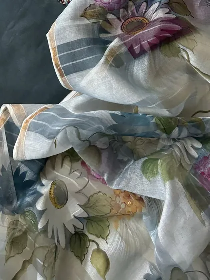 A detailed shot of the hand-painted silk chanderi dupatta, showcasing its soft floral pattern and luxurious texture.