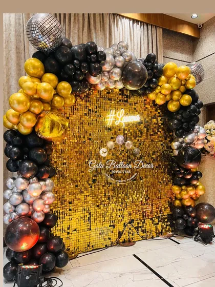 I create stunning photo backdrops that are perfect for any glam party. This setup features a shimmering gold sequin wall framed by a black, gold, and silver organic balloon arch, complete with a custom neon sign.